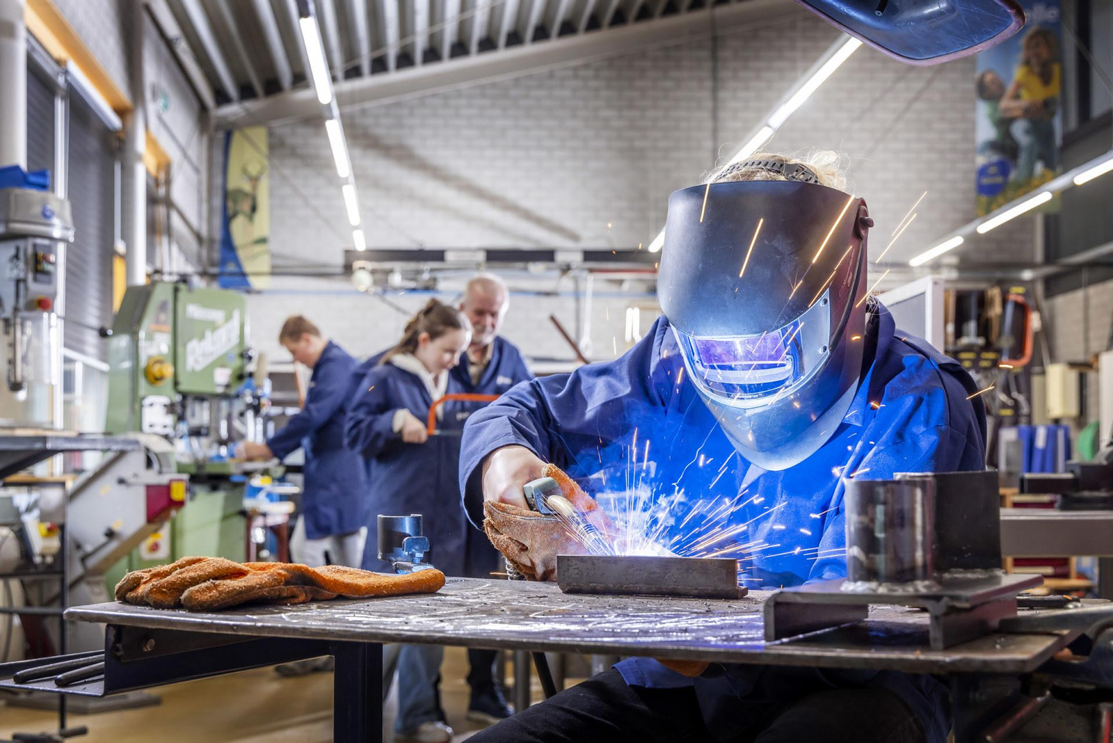 Student preparing a steel plate before welding at Flex Tradez Academy