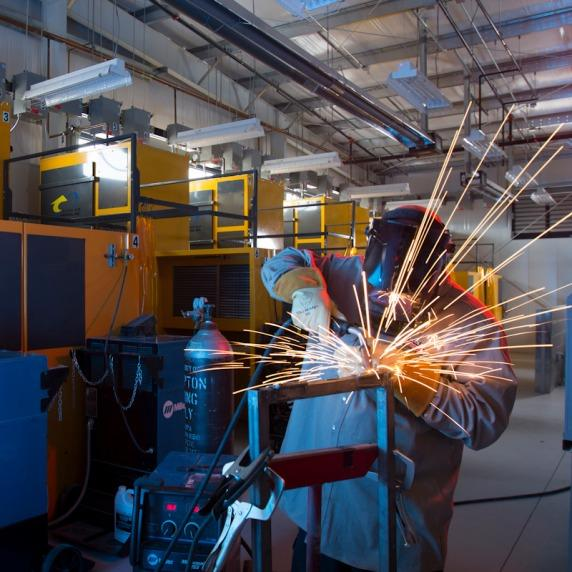 Welding students preparing a steel plate in the Flex Tradez Academy shop